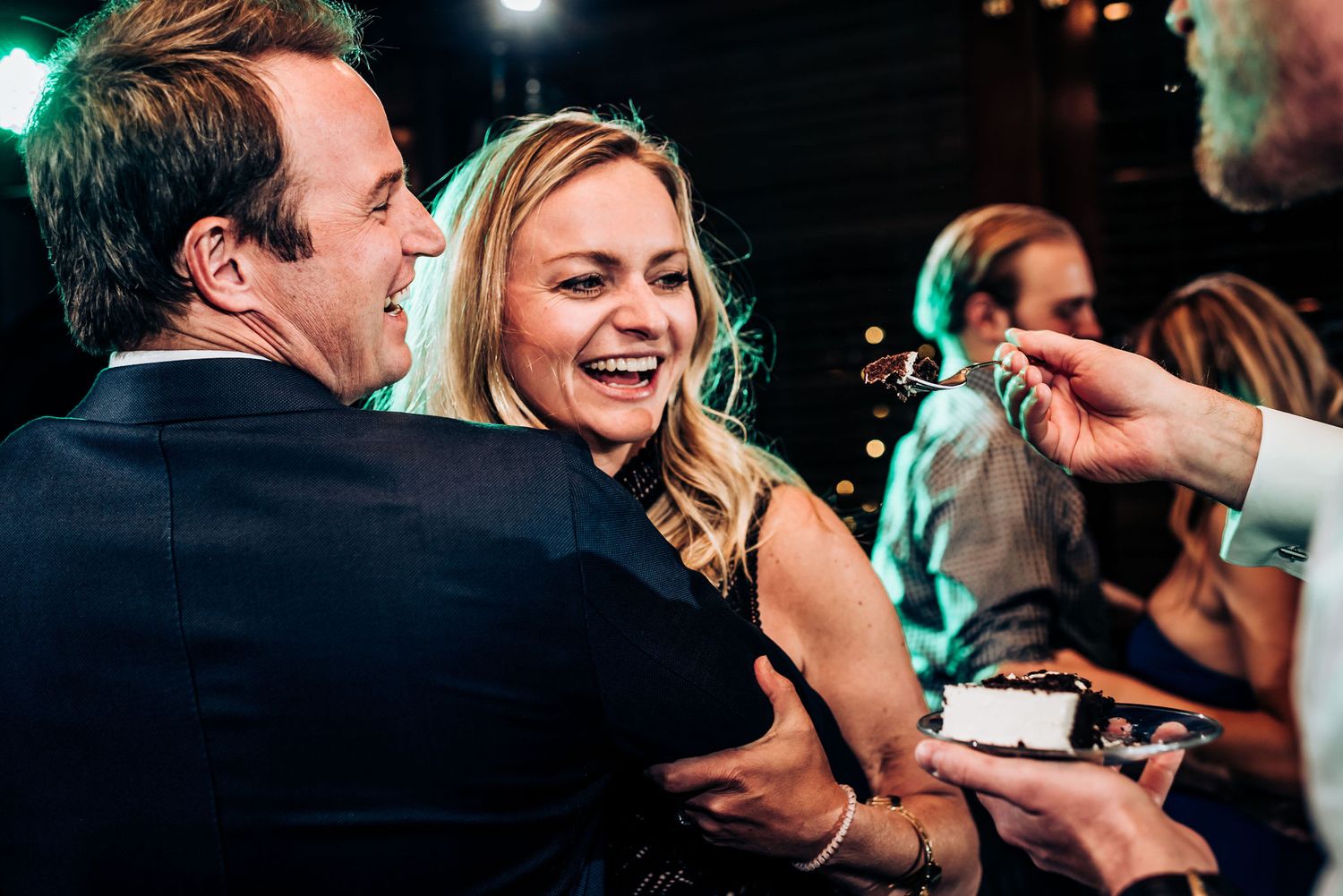 A candid moment of joy captured during a dance at an evening celebration.