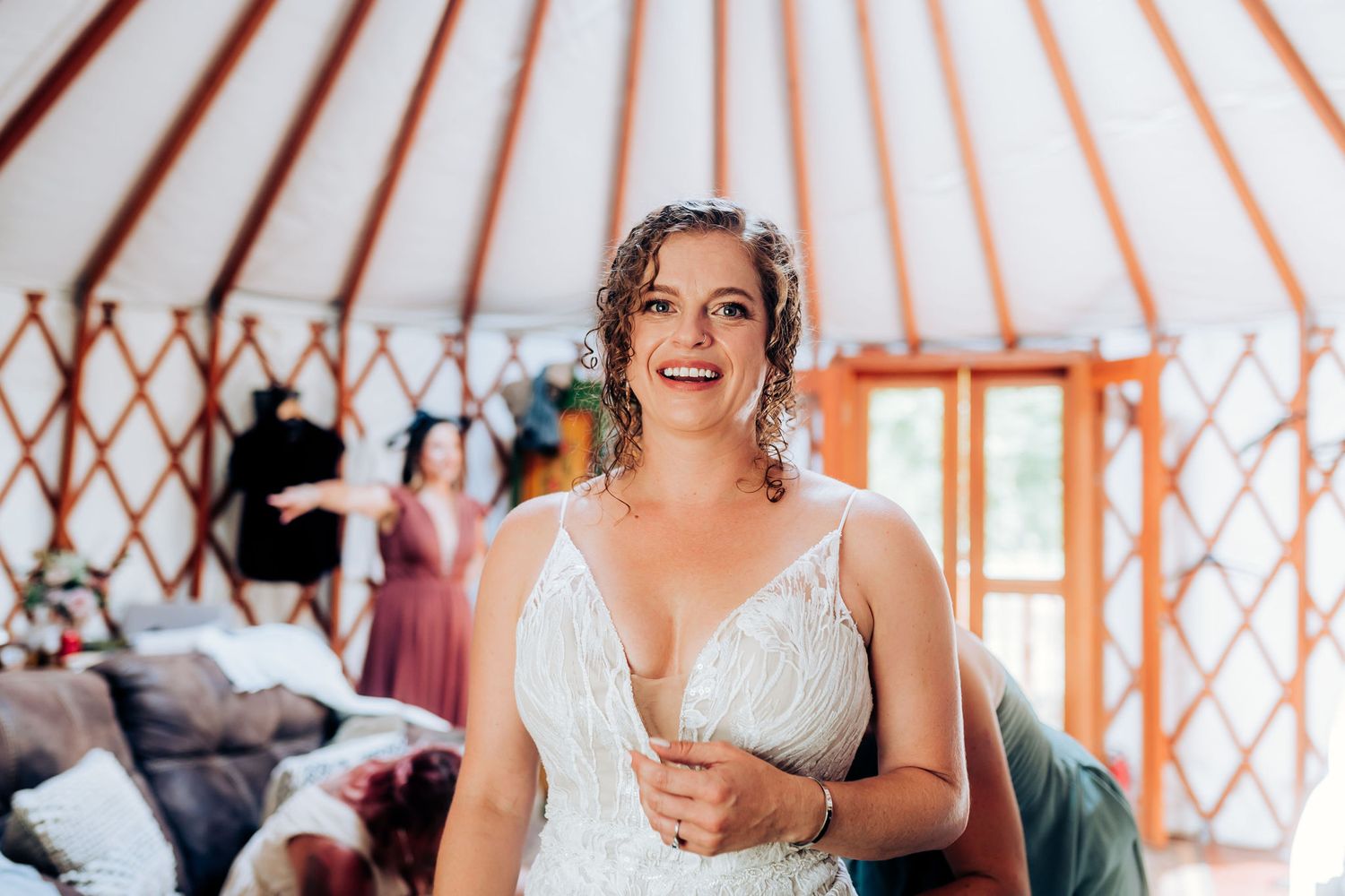 Inside a yurt with striped canvas ceiling during wedding preparations.