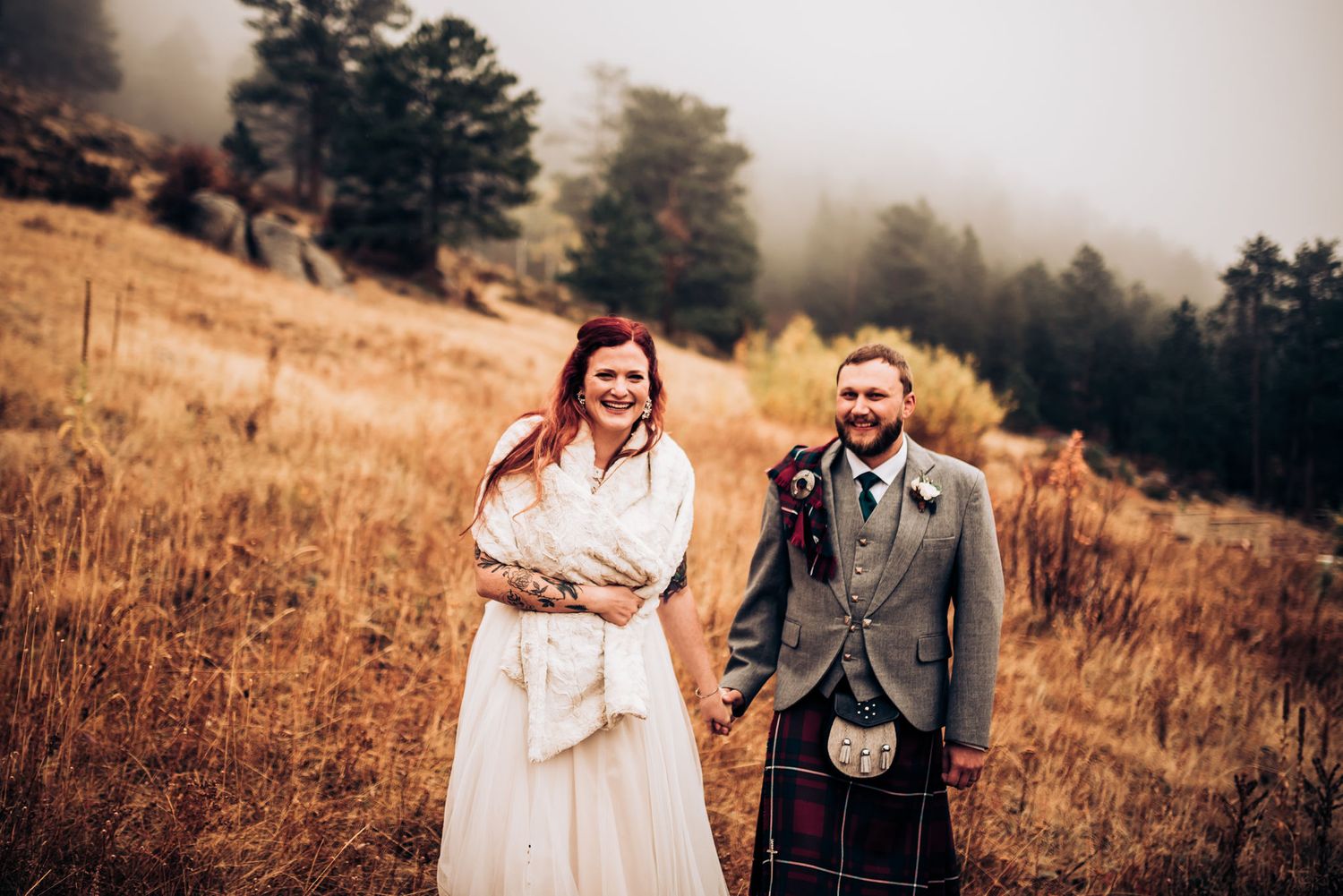 Scottish themed wedding portrait in autumn field with traditional highland dress.
