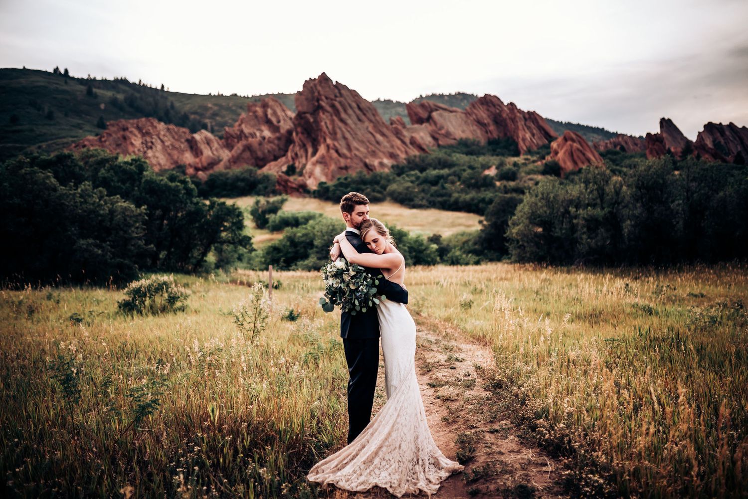 Newlyweds embrace against stunning red rock formations at Garden of the Gods.