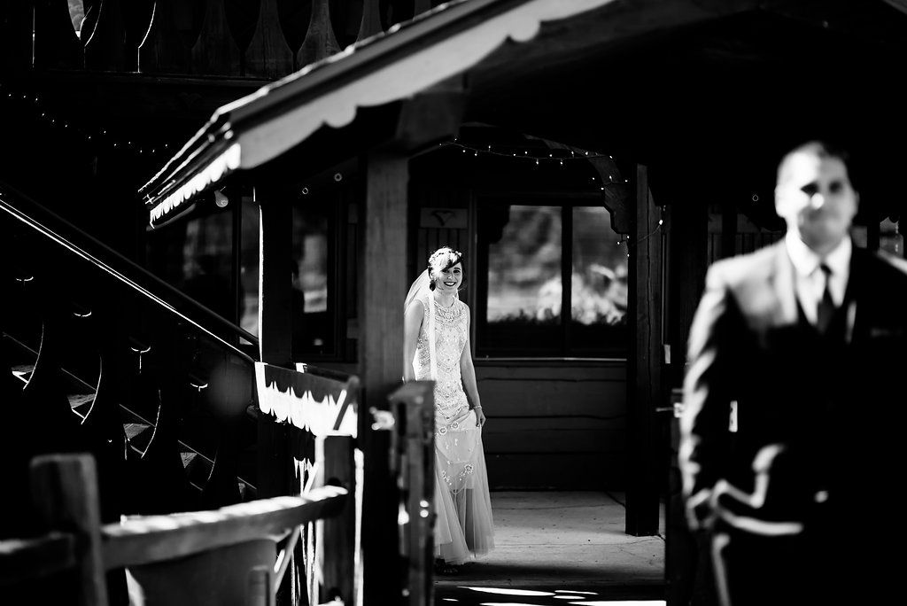 A dramatic black and white photo of people outside a building entrance.