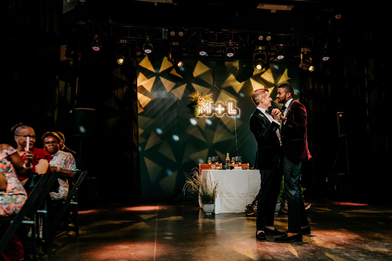 Dance floor moment during evening celebration with geometric lighting design.