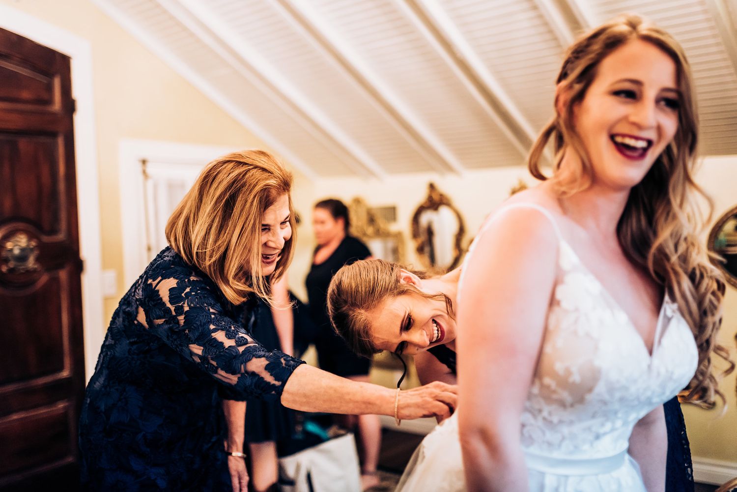 Wedding preparation scene showing excited reactions during bridal getting ready moments in a bright room.
