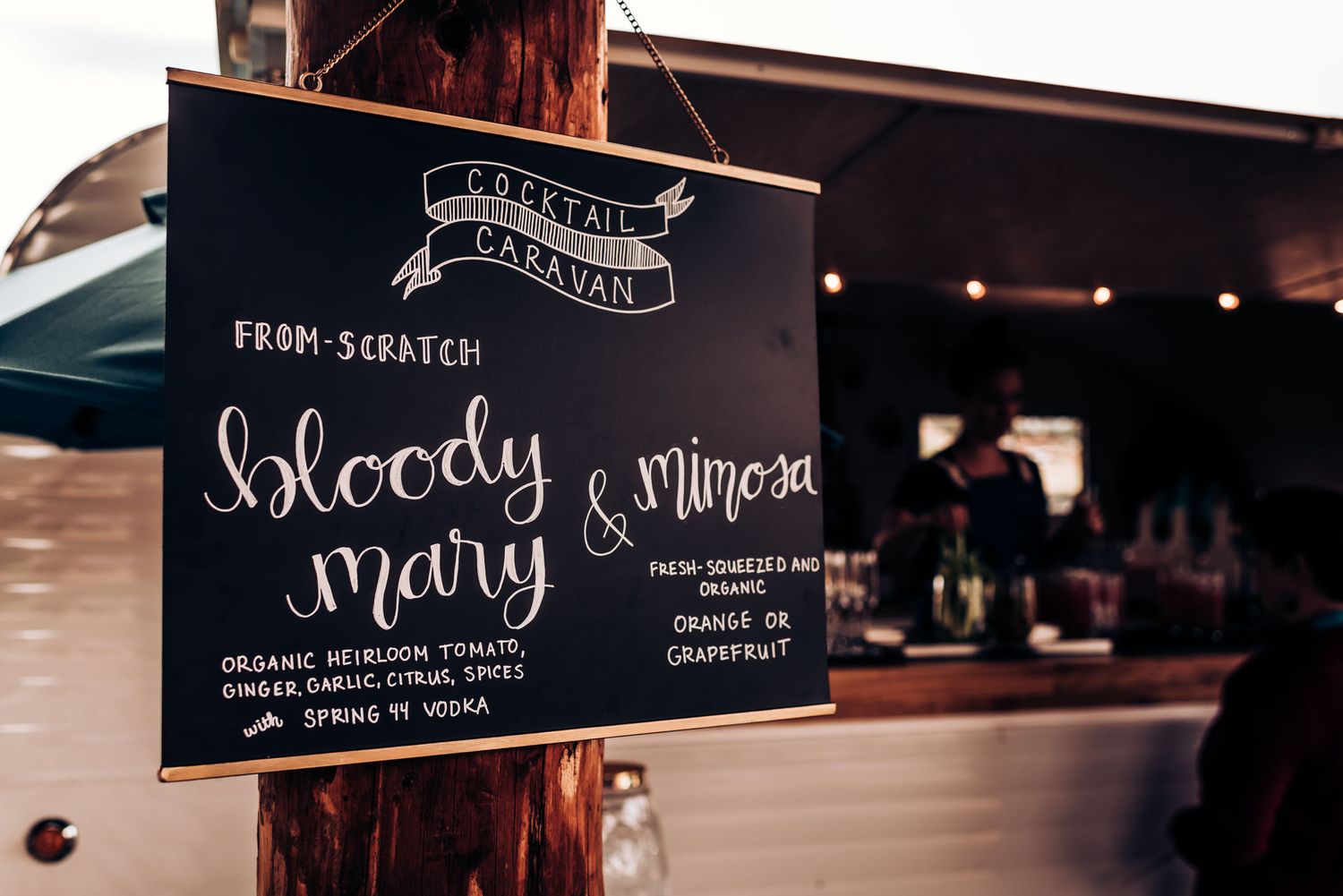 Chalkboard menu sign advertising Bloody Mary cocktails in vintage style lettering.