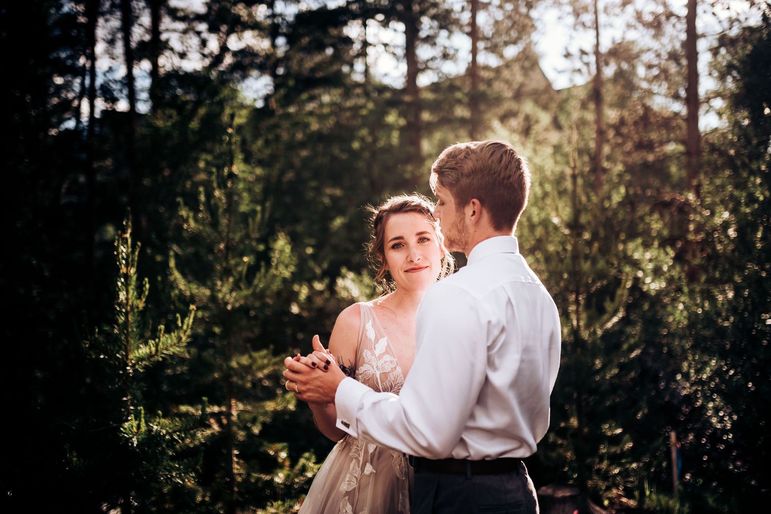 A candid dance moment photographed in a serene forest setting with beautiful natural lighting.