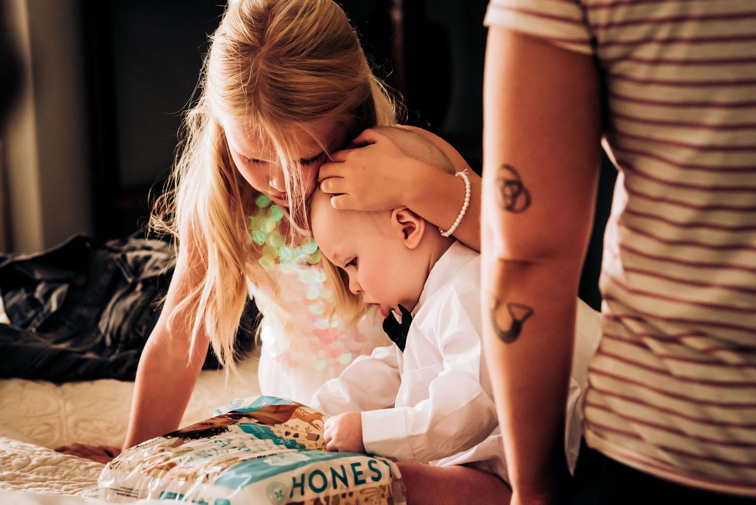 Parent and child reading a book together on the floor.