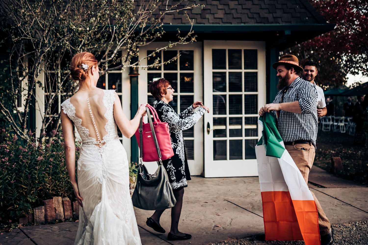 Wedding celebration with Irish flag displayed outside building entrance.