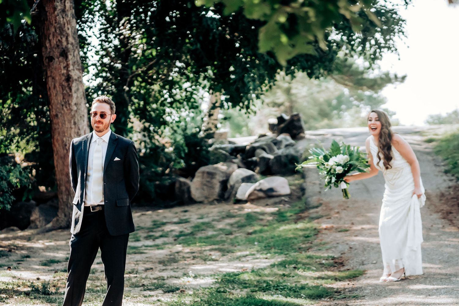 A couple shares a first look moment in a serene outdoor garden setting during their wedding.