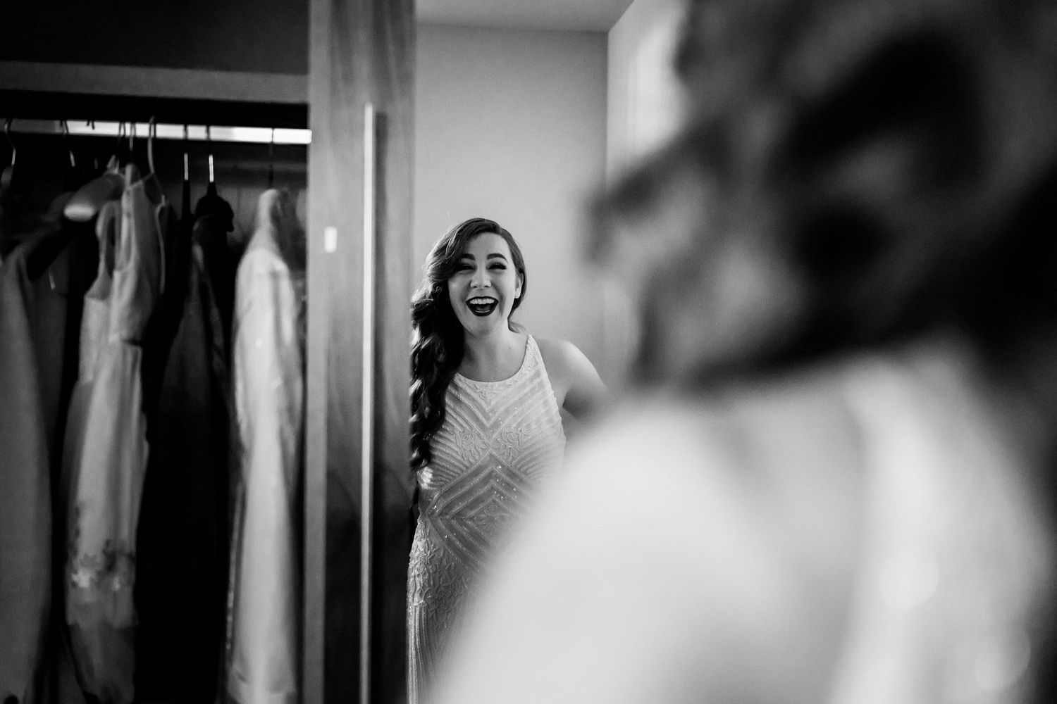 Black and white portrait of joyful laughter reflected in mirror.