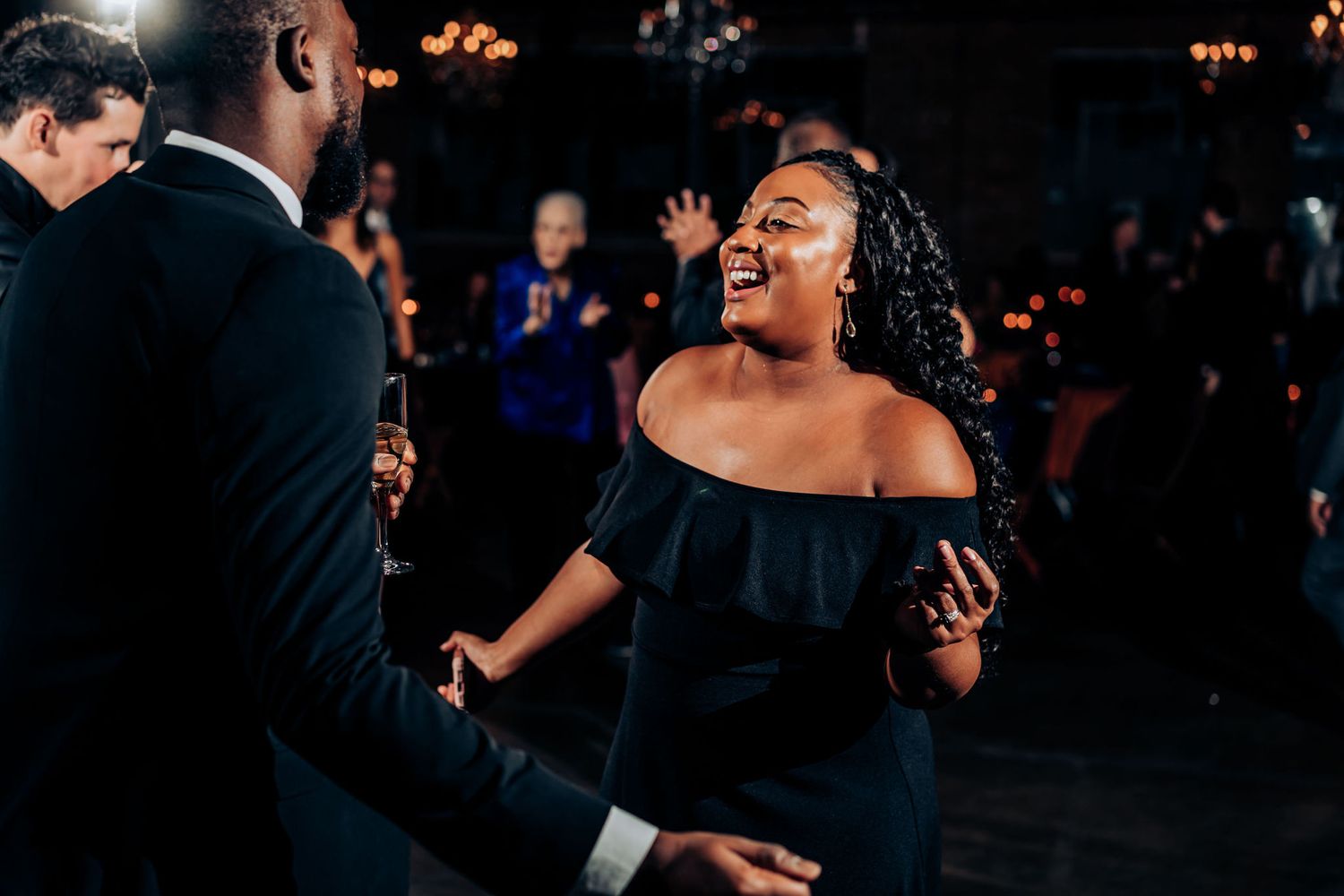 Joyful dancing and celebration at evening wedding reception.