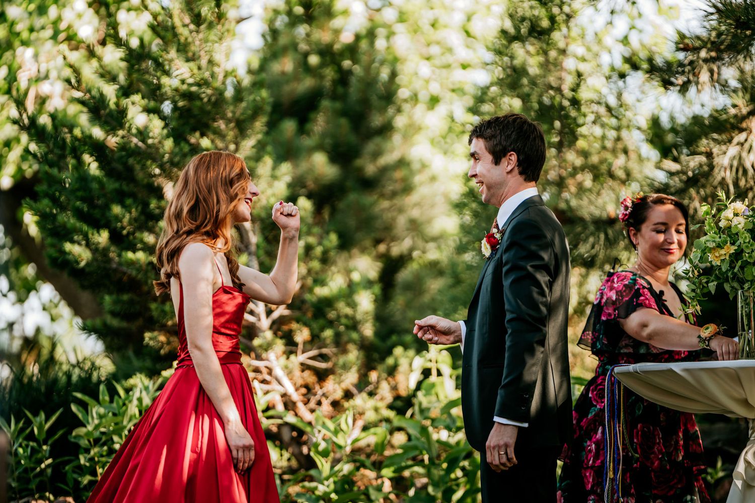 A couple exchanges vows during an intimate garden wedding ceremony in vibrant natural surroundings.