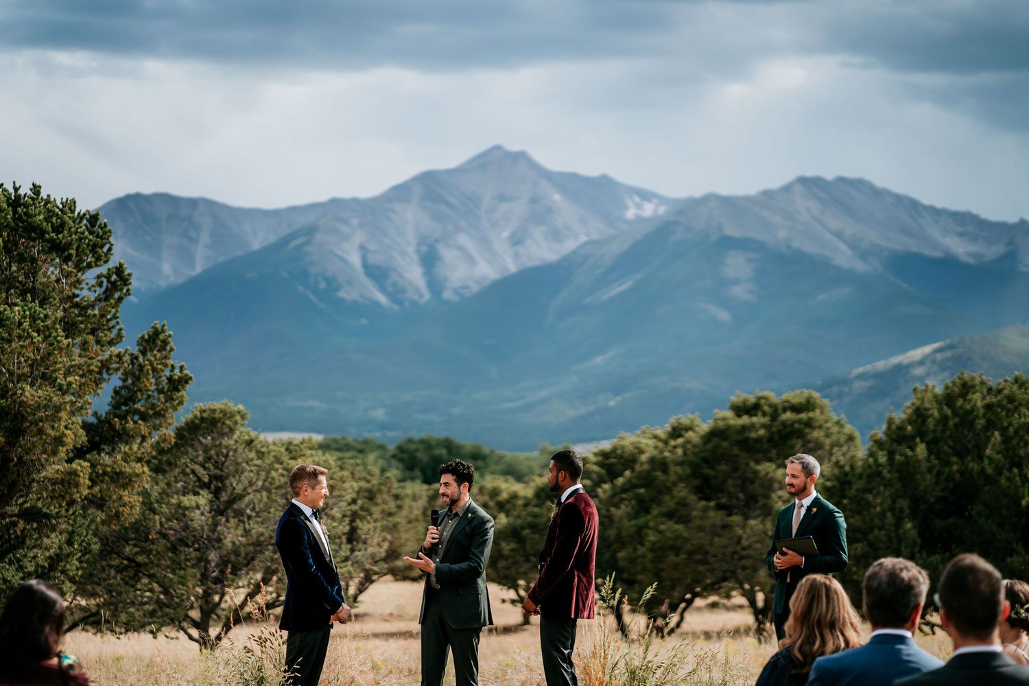 Intimate outdoor wedding ceremony against a backdrop of majestic mountain peaks.