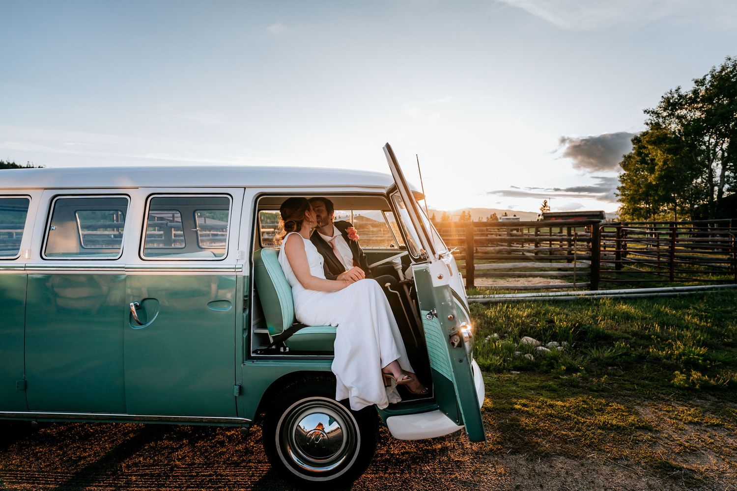 A romantic wedding moment captured inside a classic teal VW bus at sunset.