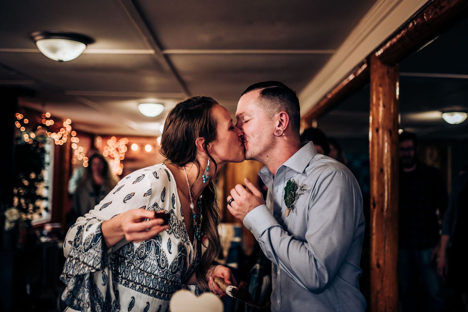 A candid moment shared between two people in a cozy indoor setting with ambient lighting.