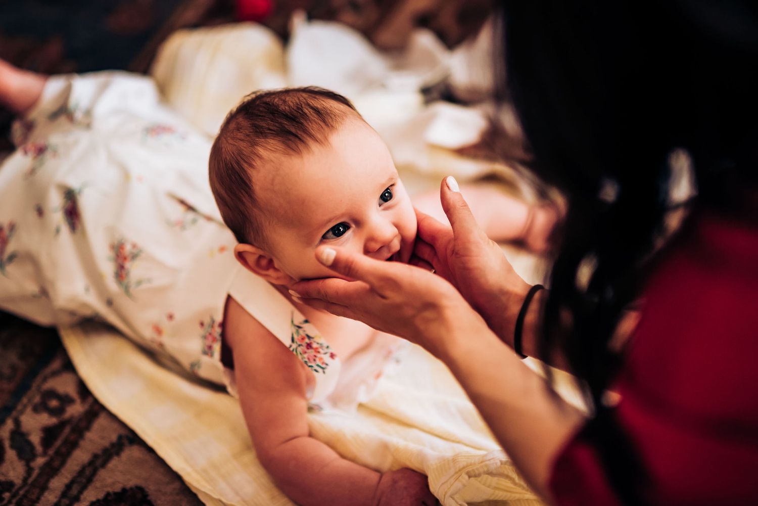 Candid moment captured with infant during intimate family photoshoot.