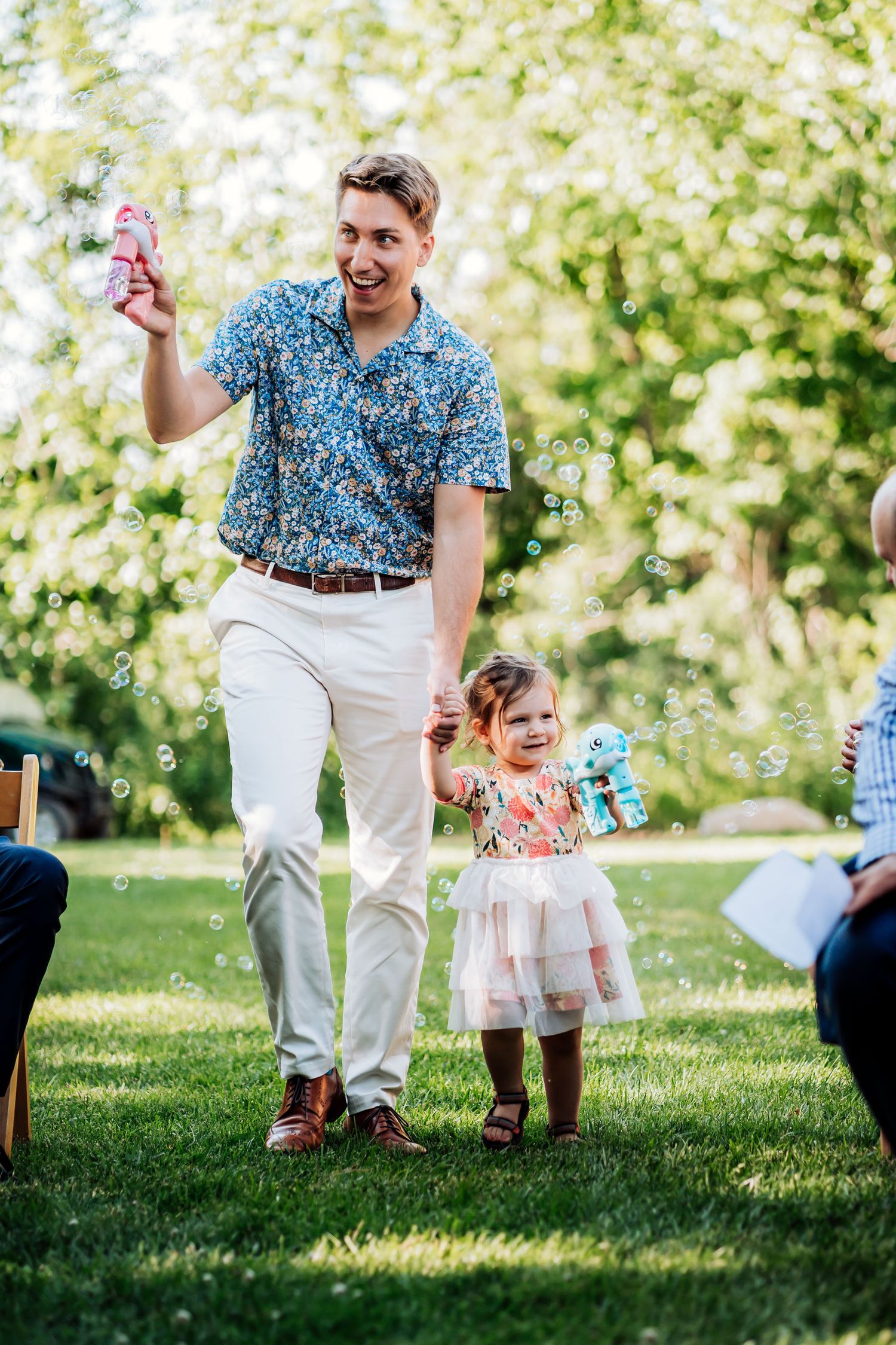 Joyful moments at an outdoor celebration with attendees in summer attire.