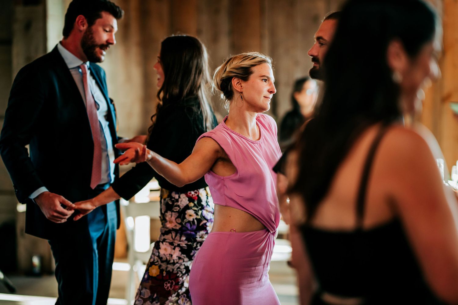 Guests dancing and enjoying themselves at a lively indoor celebration.
