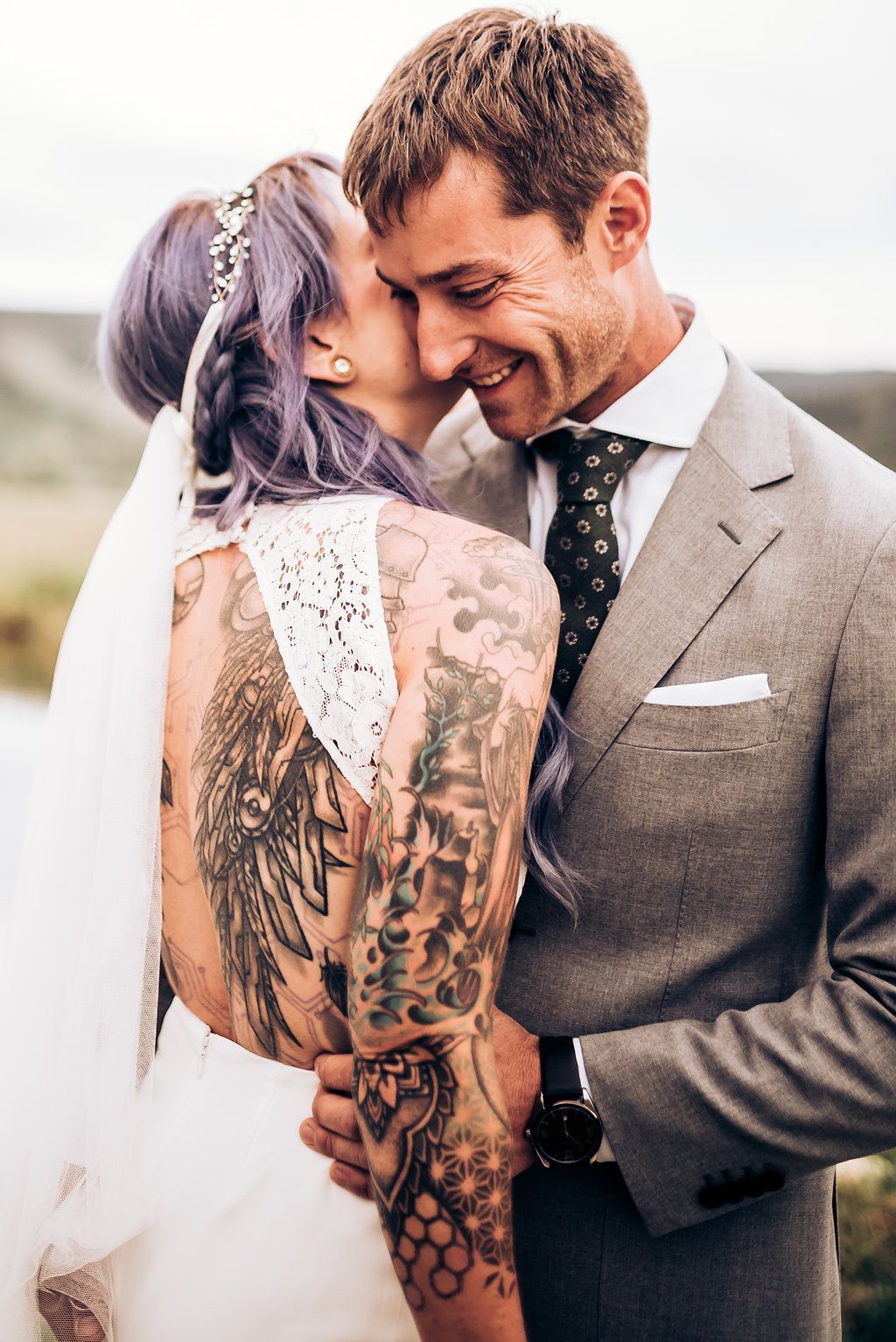 Artistic wedding portrait highlighting intricate back tattoo and elegant bridal style.