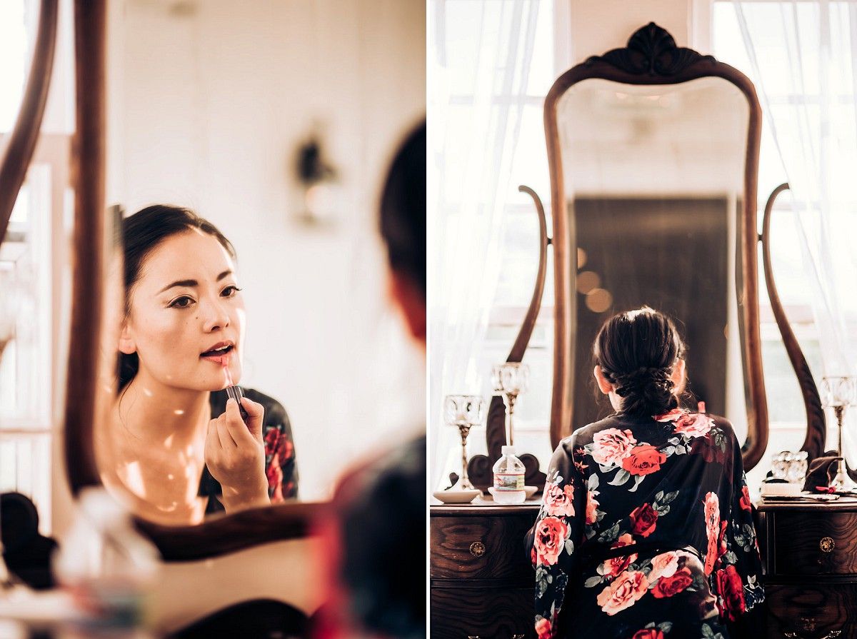 Reflection in ornate vintage mirror showing preparation scene with floral robe.