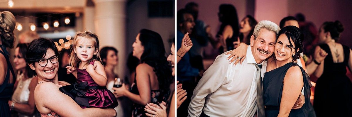 Guests enjoying themselves during a festive indoor celebration with pink mood lighting.