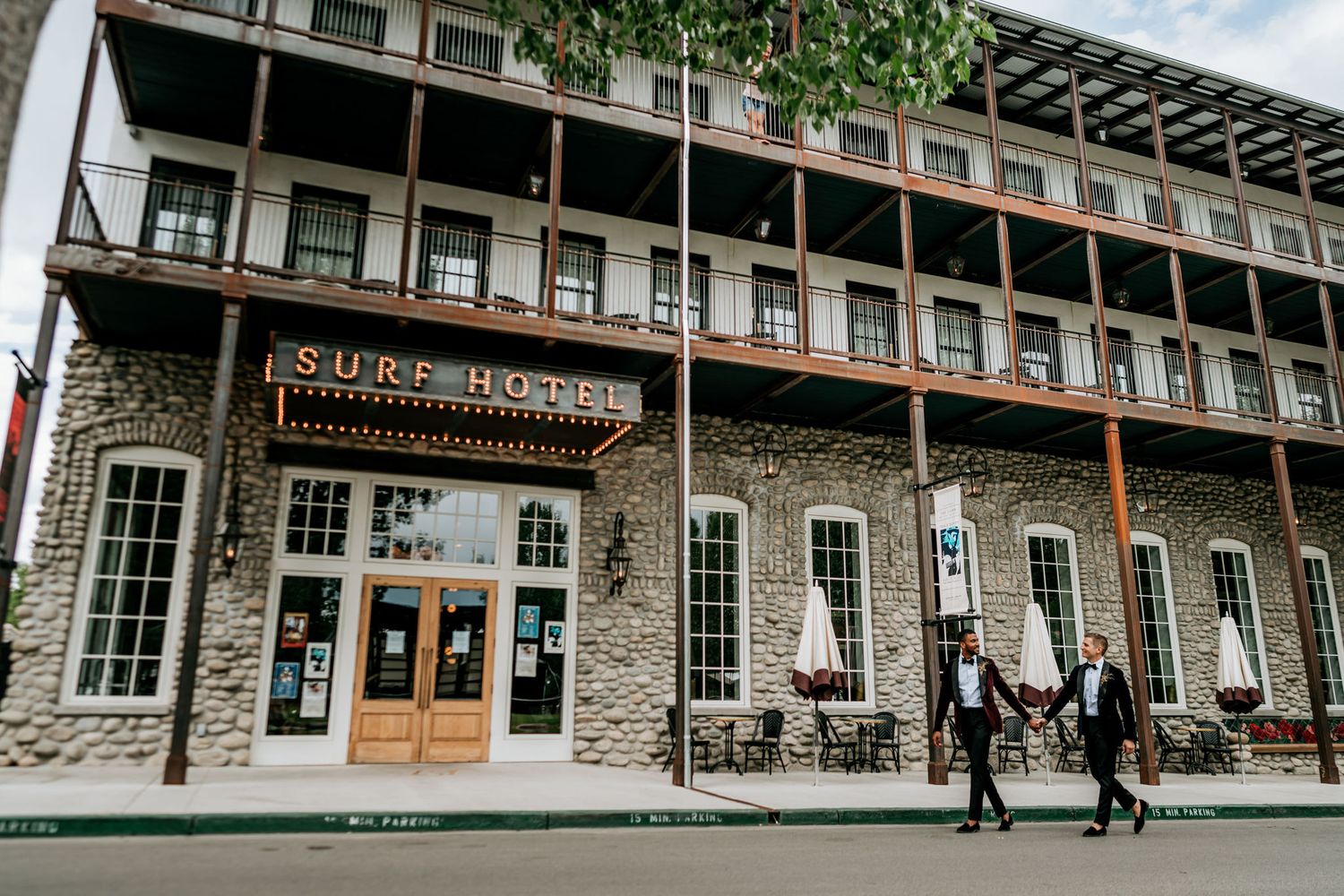 Historic stone building exterior with wooden balconies and decorative signage.