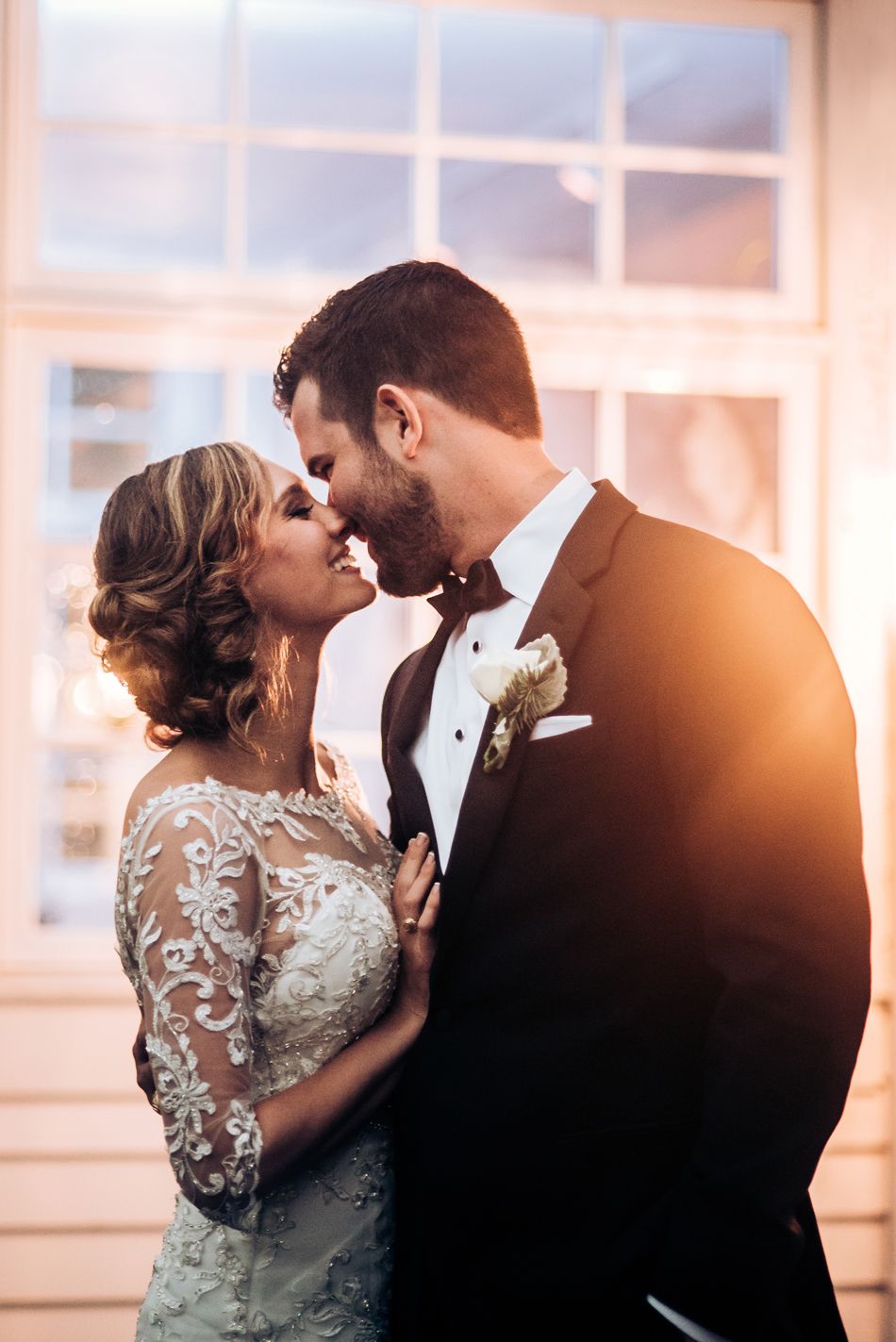 Intimate wedding portrait with warm lighting and delicate lace details.