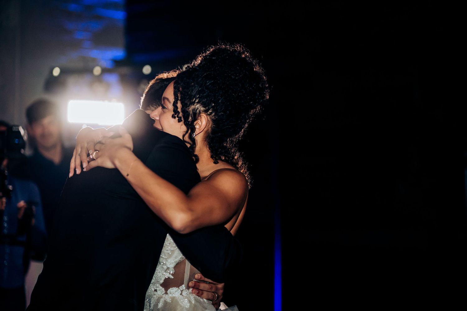 Silhouetted couple shares an intimate dance moment at a wedding reception.