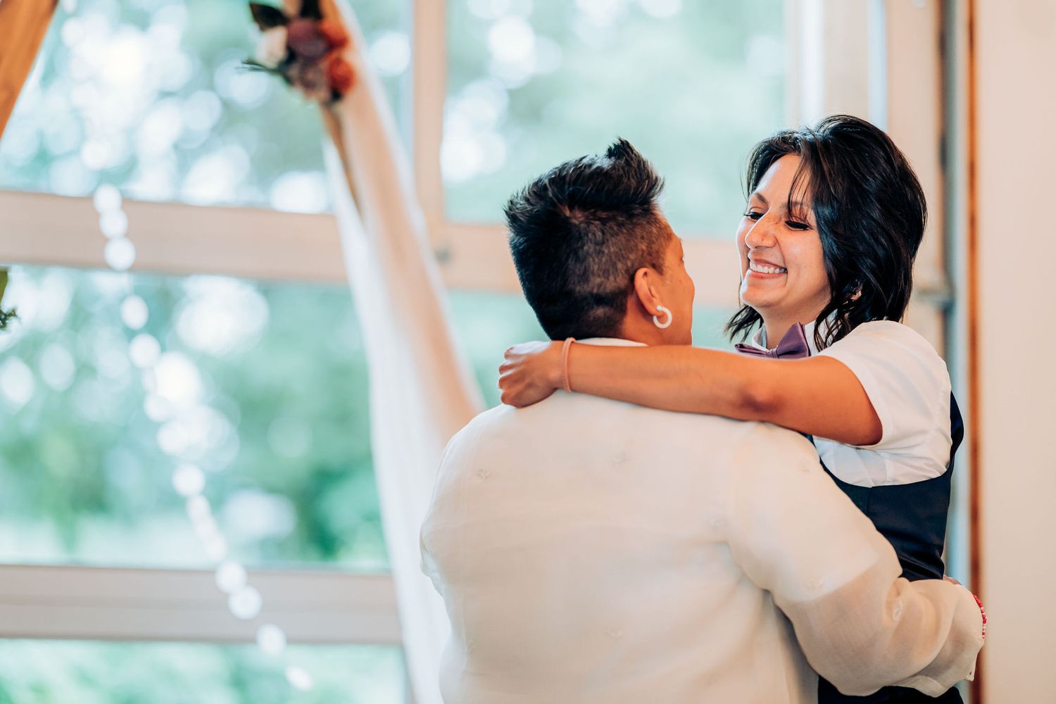 A celebratory dance moment between two people during a wedding reception.