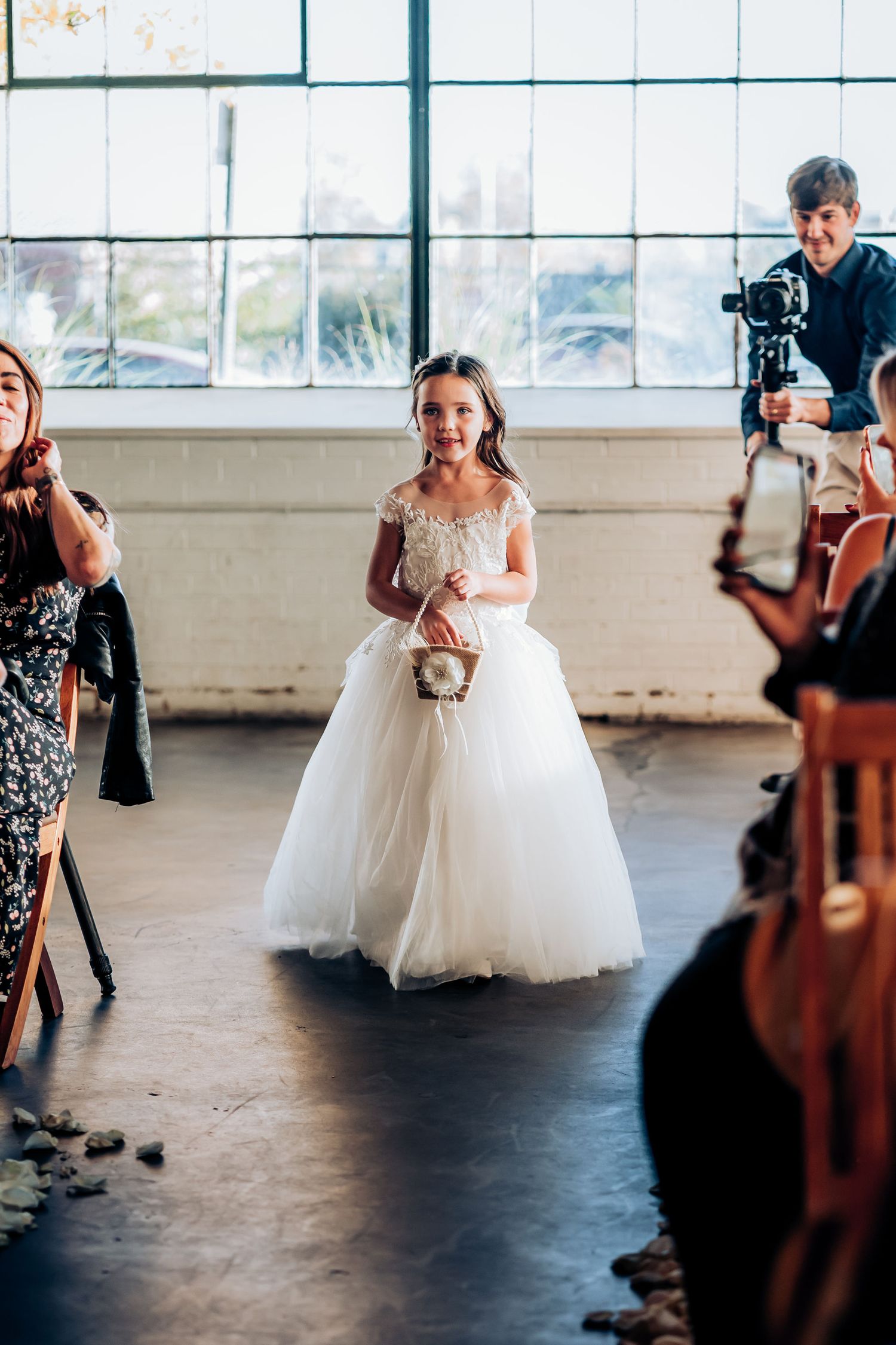 Wedding photoshoot scene with photographers capturing a bride in a tulle ballgown.