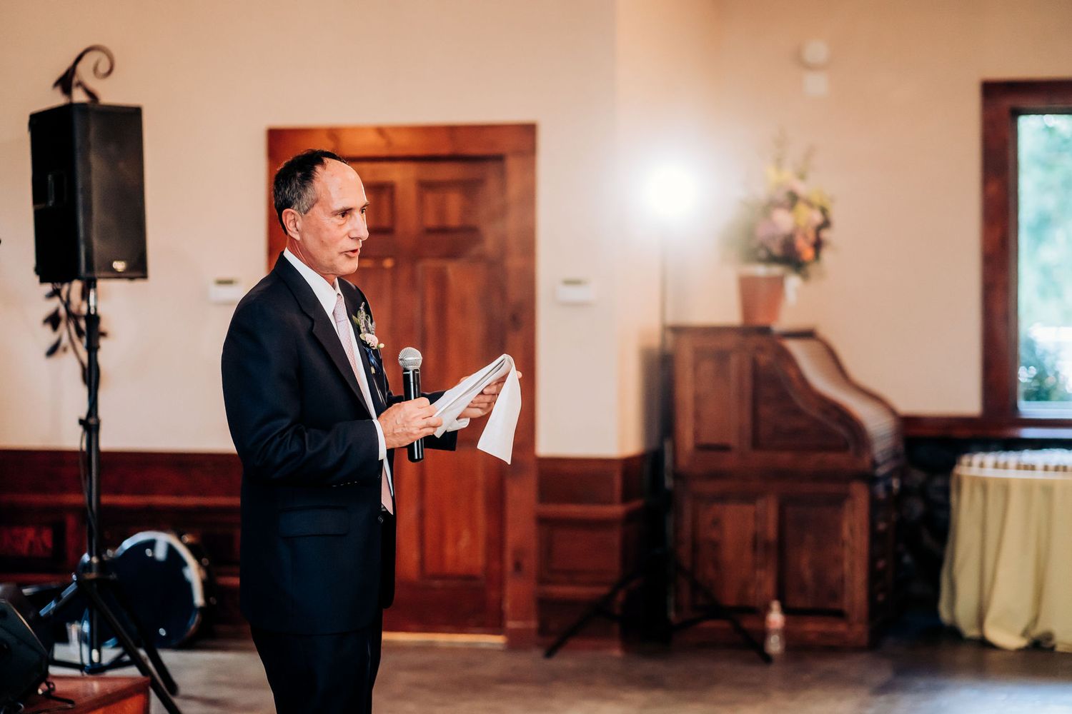 A speaker addresses the wedding guests during a reception celebration.