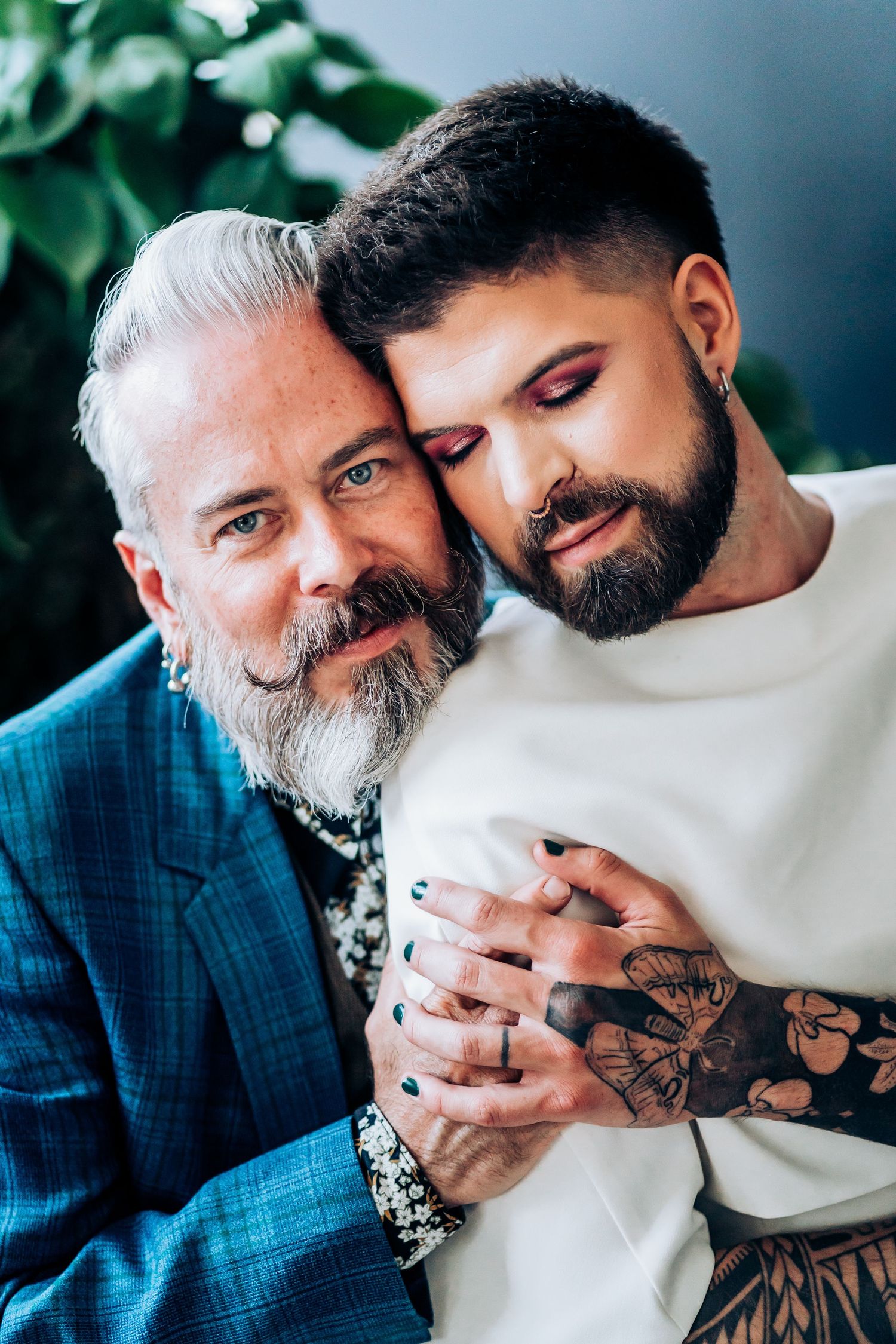 Two people sharing an intimate moment against a blurred background.