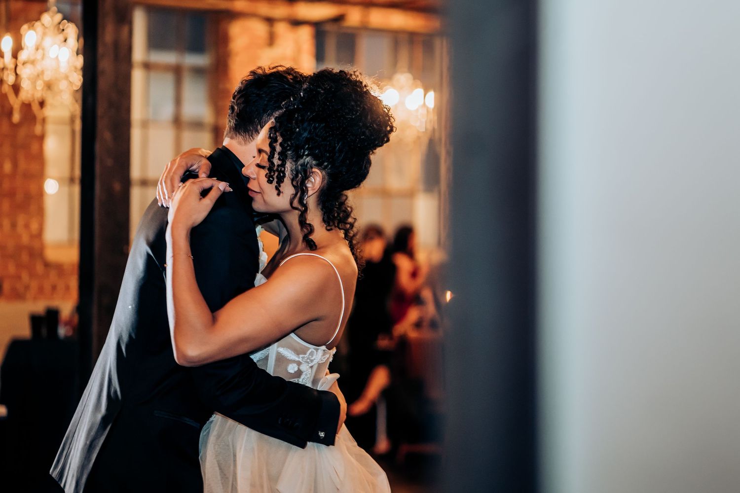 Indoor wedding reception with warm lighting and elegant decor.