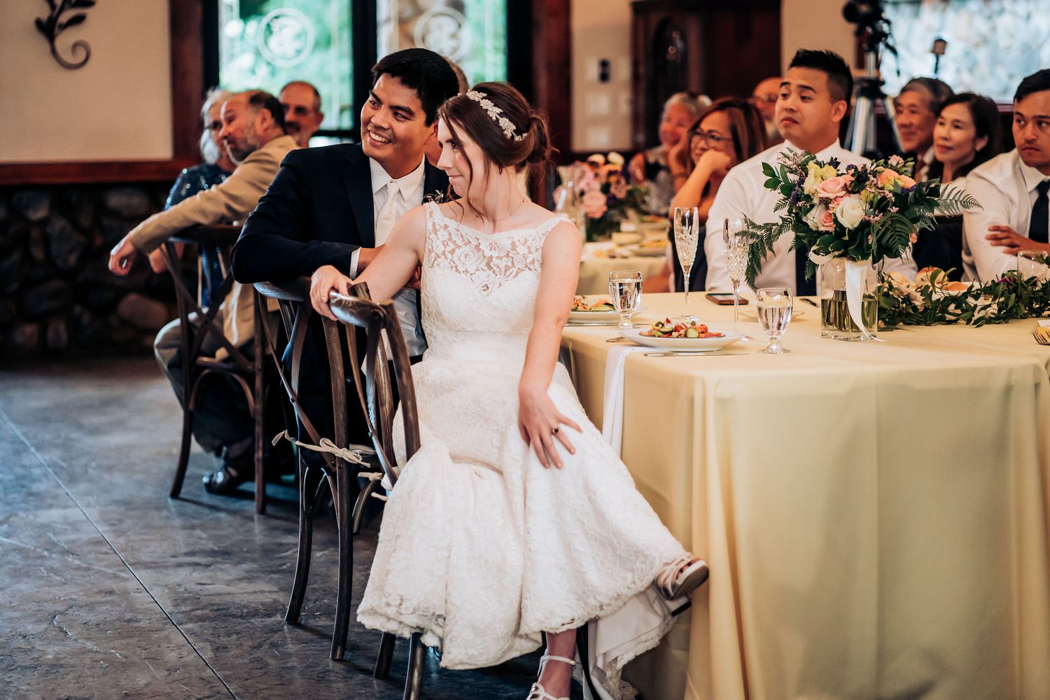 A celebration moment during the wedding reception with decorated tables and chairs.