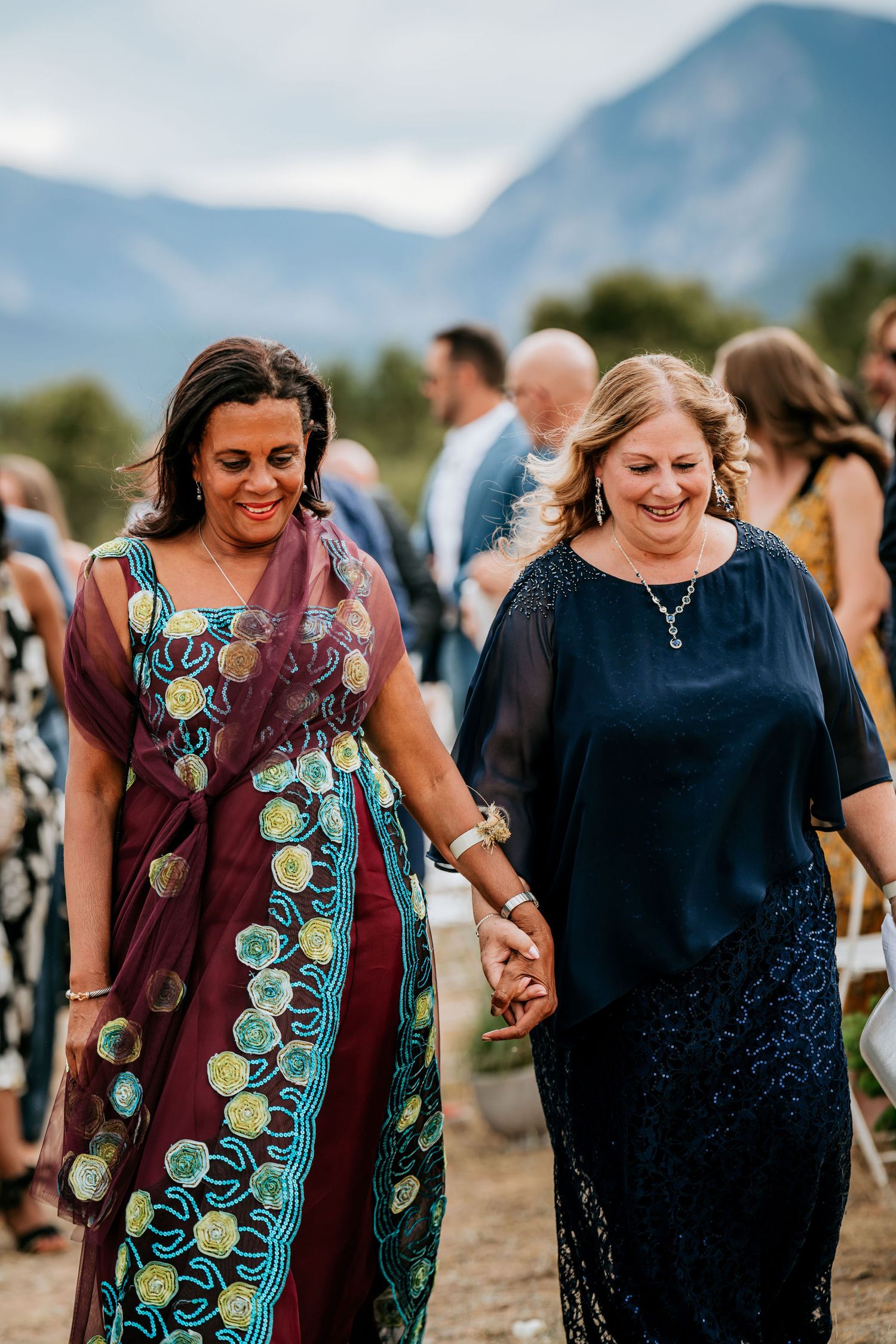 Wedding guests enjoying the celebration with a majestic mountain view in the background.