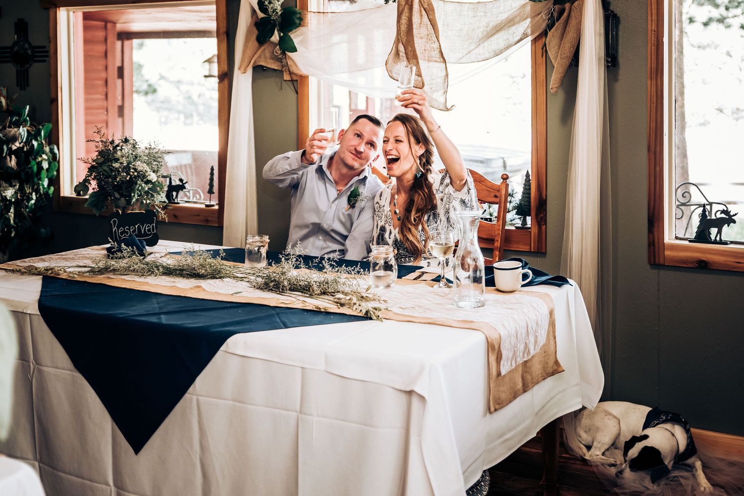 A celebratory moment captured at an elegant table setting with decorative navy blue accents.