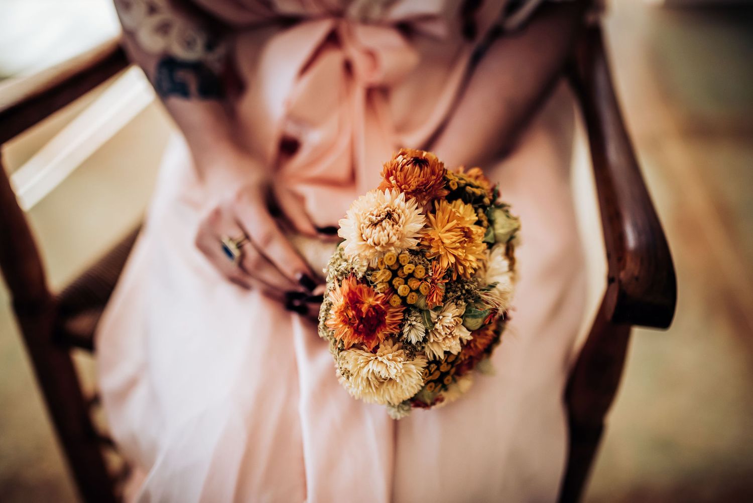 Beautiful autumn-toned wedding bouquet with dried flowers and warm colors.