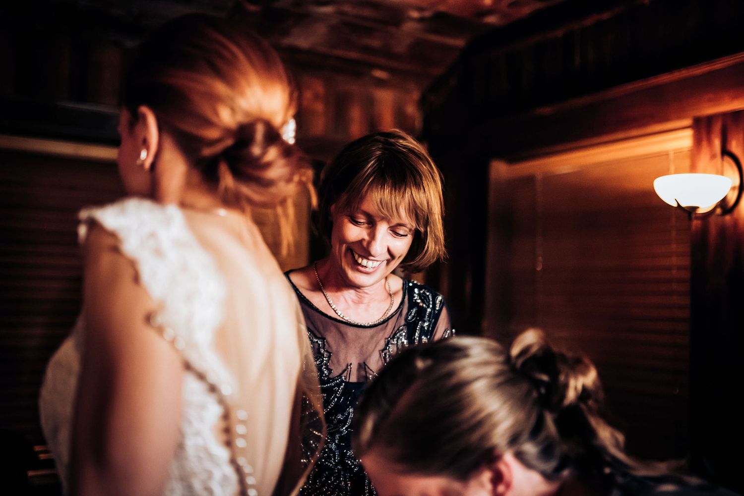 People sharing laughter at an evening social gathering.
