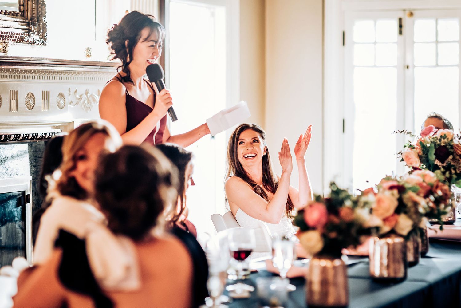 Celebration speech being delivered during formal dinner with elegant table settings and decor.