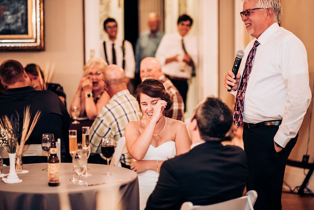 Emotional moment during wedding reception toasts and speeches.