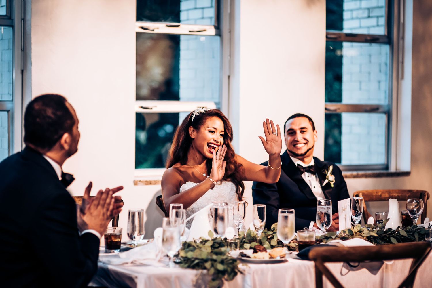 Joyful moment shared during wedding reception dinner.