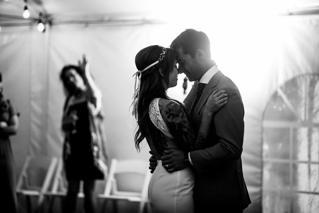 Black and white romantic dance moment captured at wedding reception.