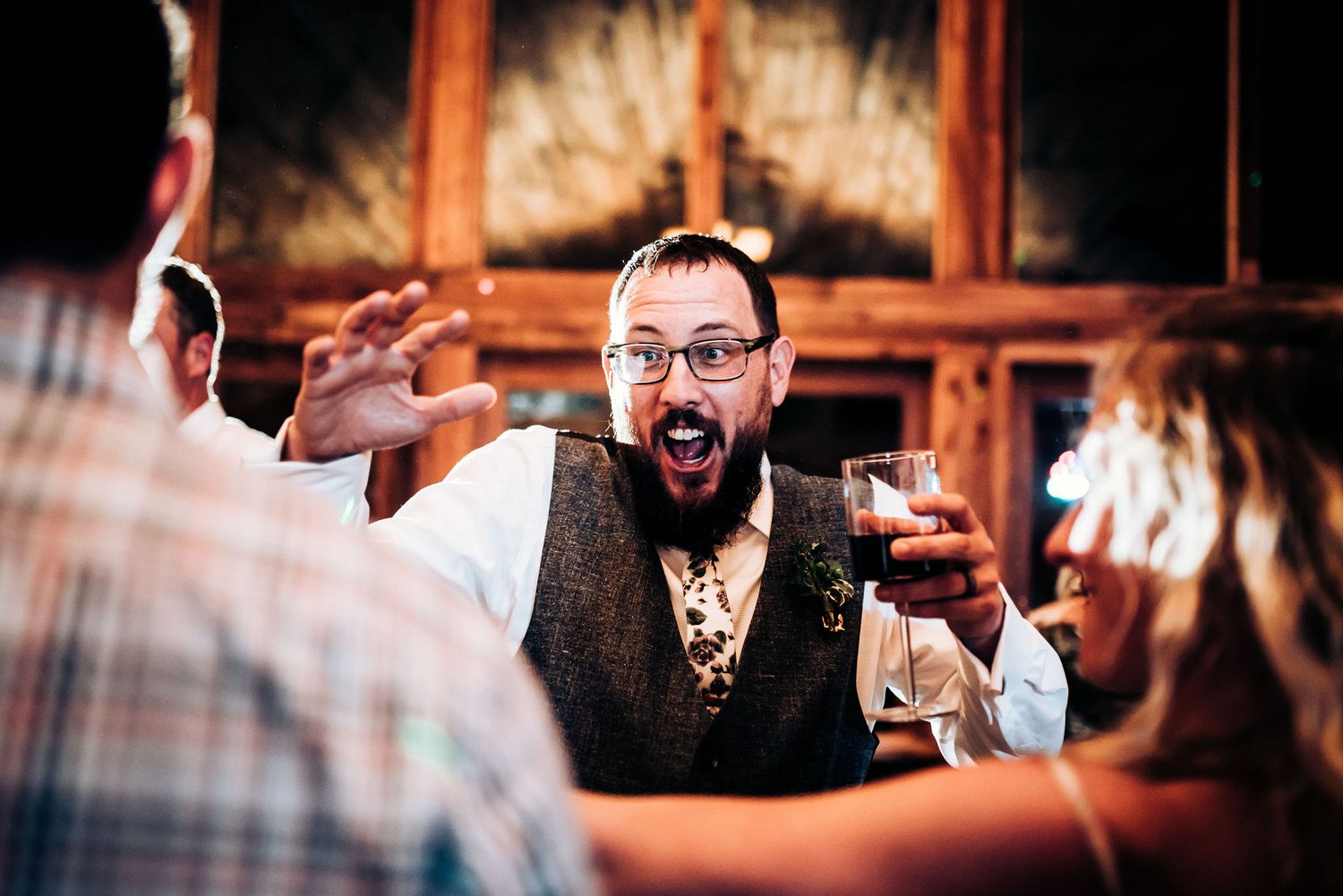Animated guest reacting with excitement during reception festivities.