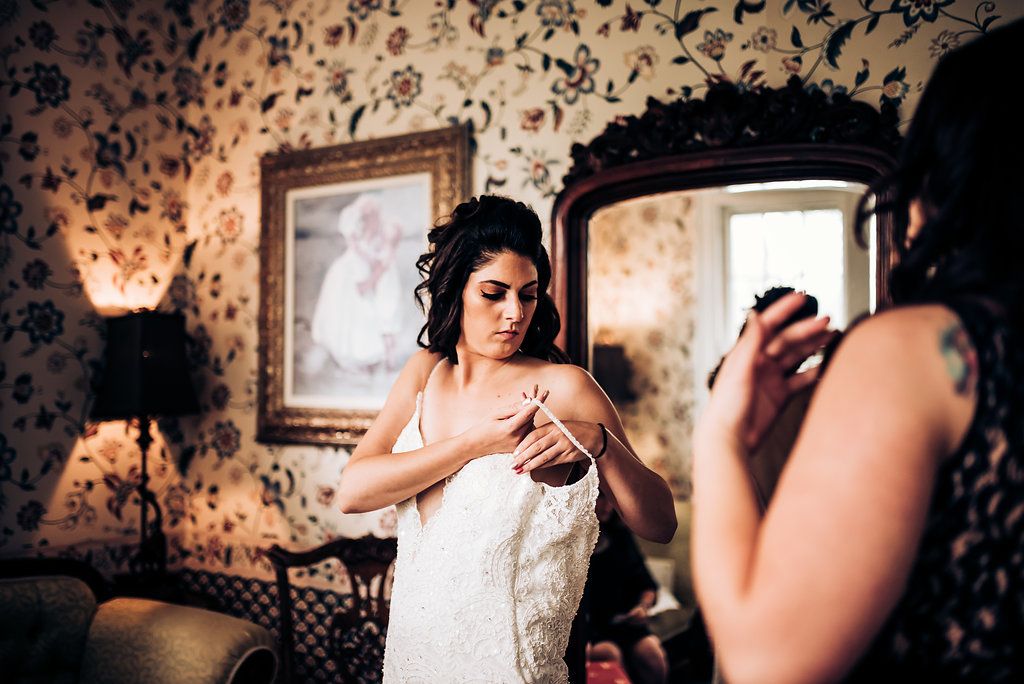 A reflection of wedding day preparations in an ornate vintage mirror.