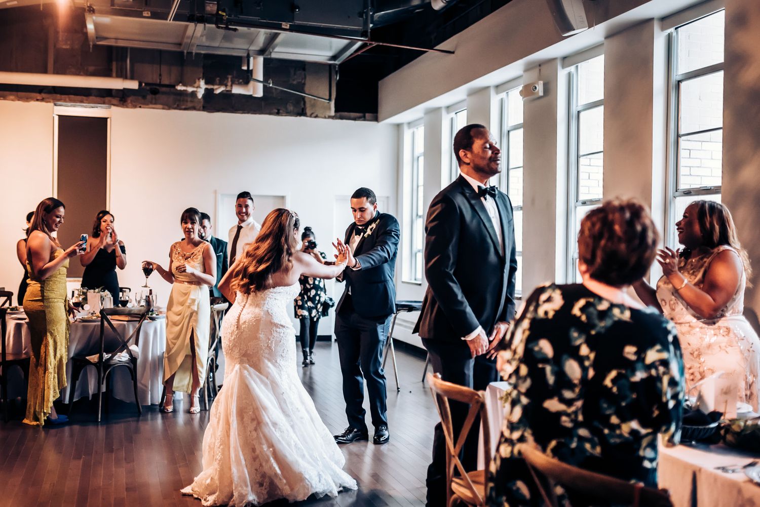 Wedding celebration in modern venue with guests enjoying festivities.