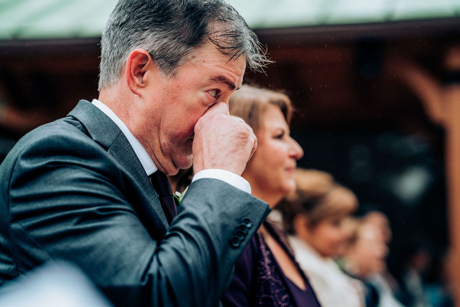 An emotional moment captured during an outdoor wedding ceremony.