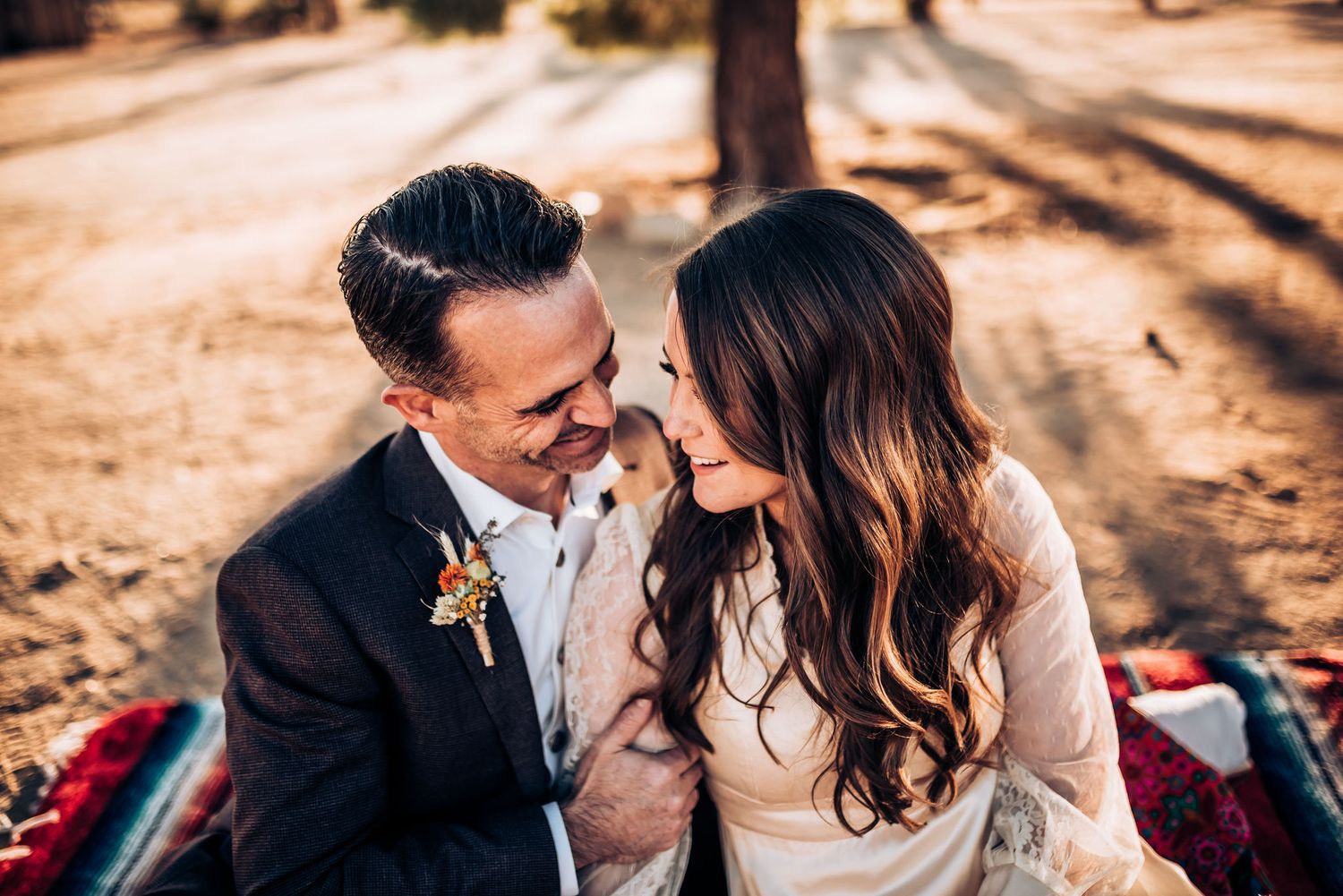 A couple shares a loving moment during their outdoor wedding photoshoot.
