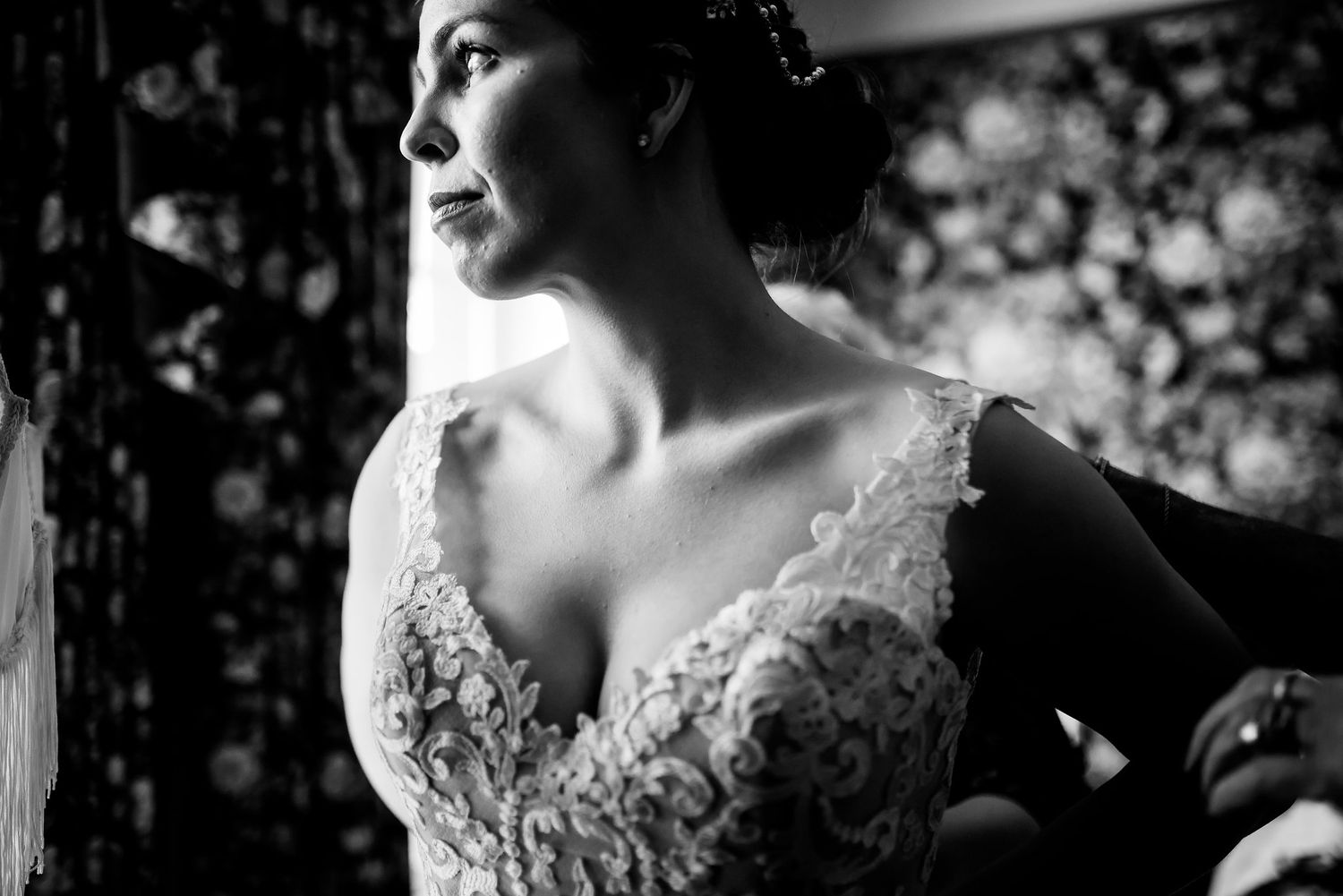 A dramatic black and white bridal portrait highlighting lace details.