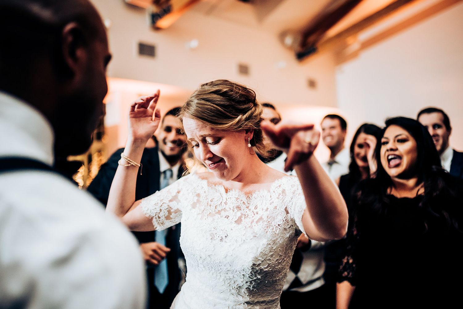 Guests enjoying an energetic dance party at a wedding reception celebration.