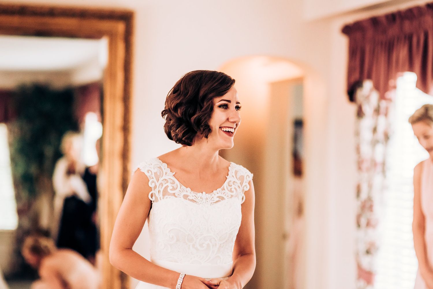 Beautiful lace detail wedding dress worn in indoor setting.