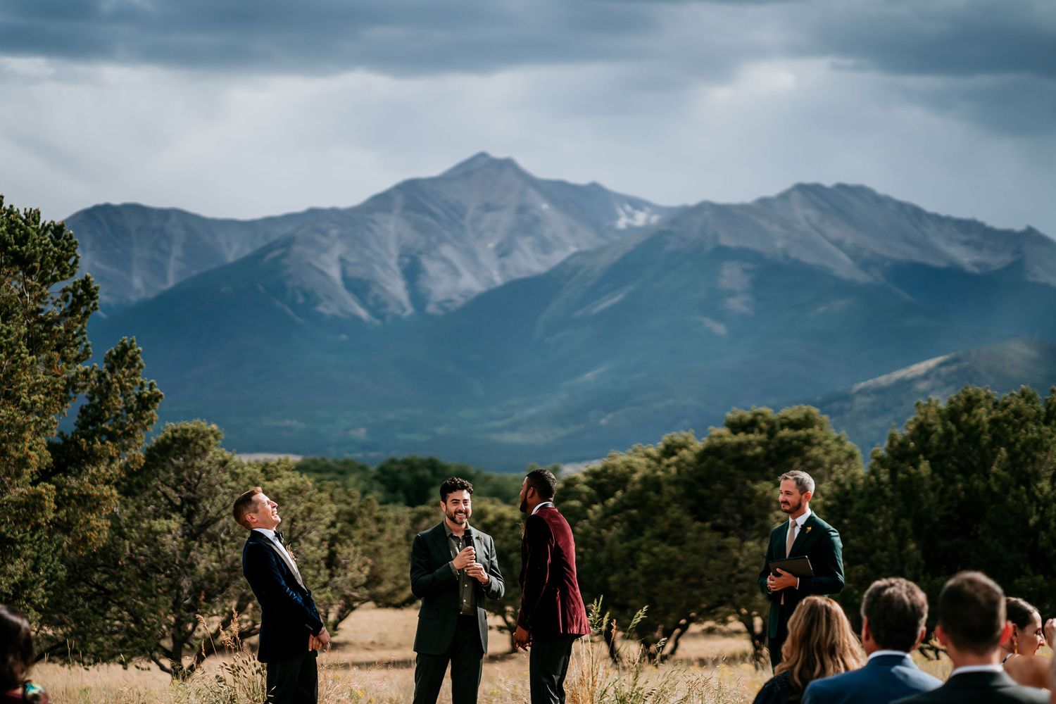 Wedding ceremony in process with mountain ranges creating a stunning natural backdrop.